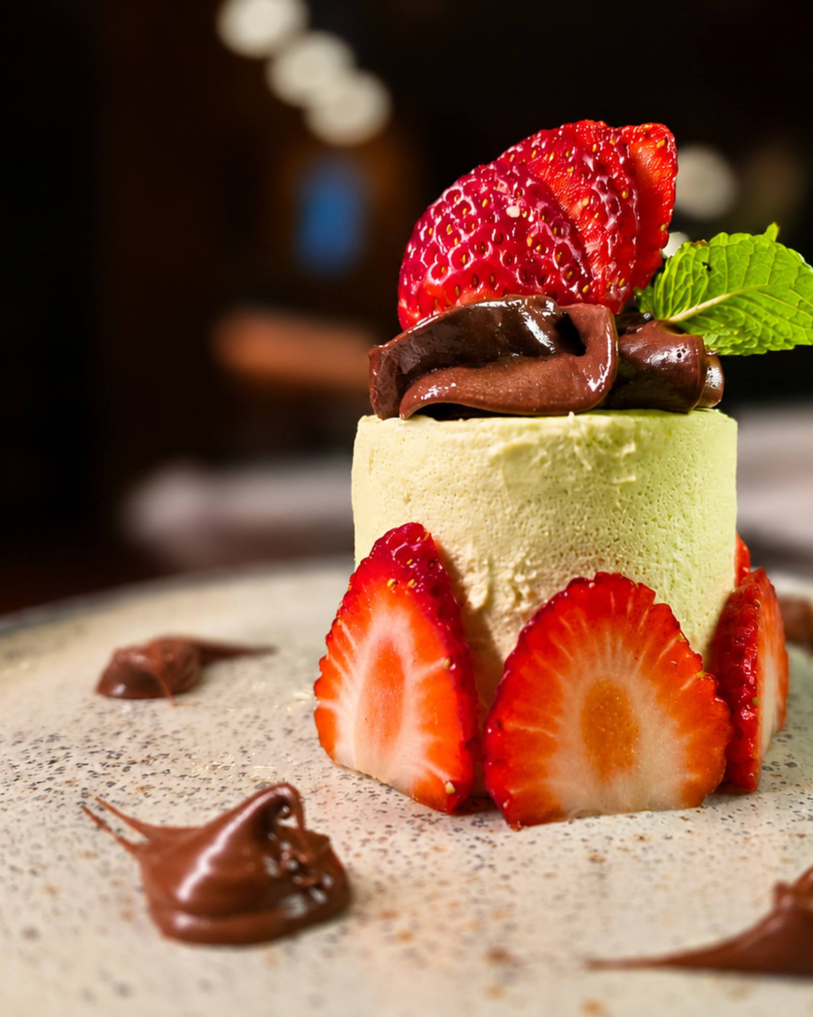 Pistachio dessert with strawberries and chocolate